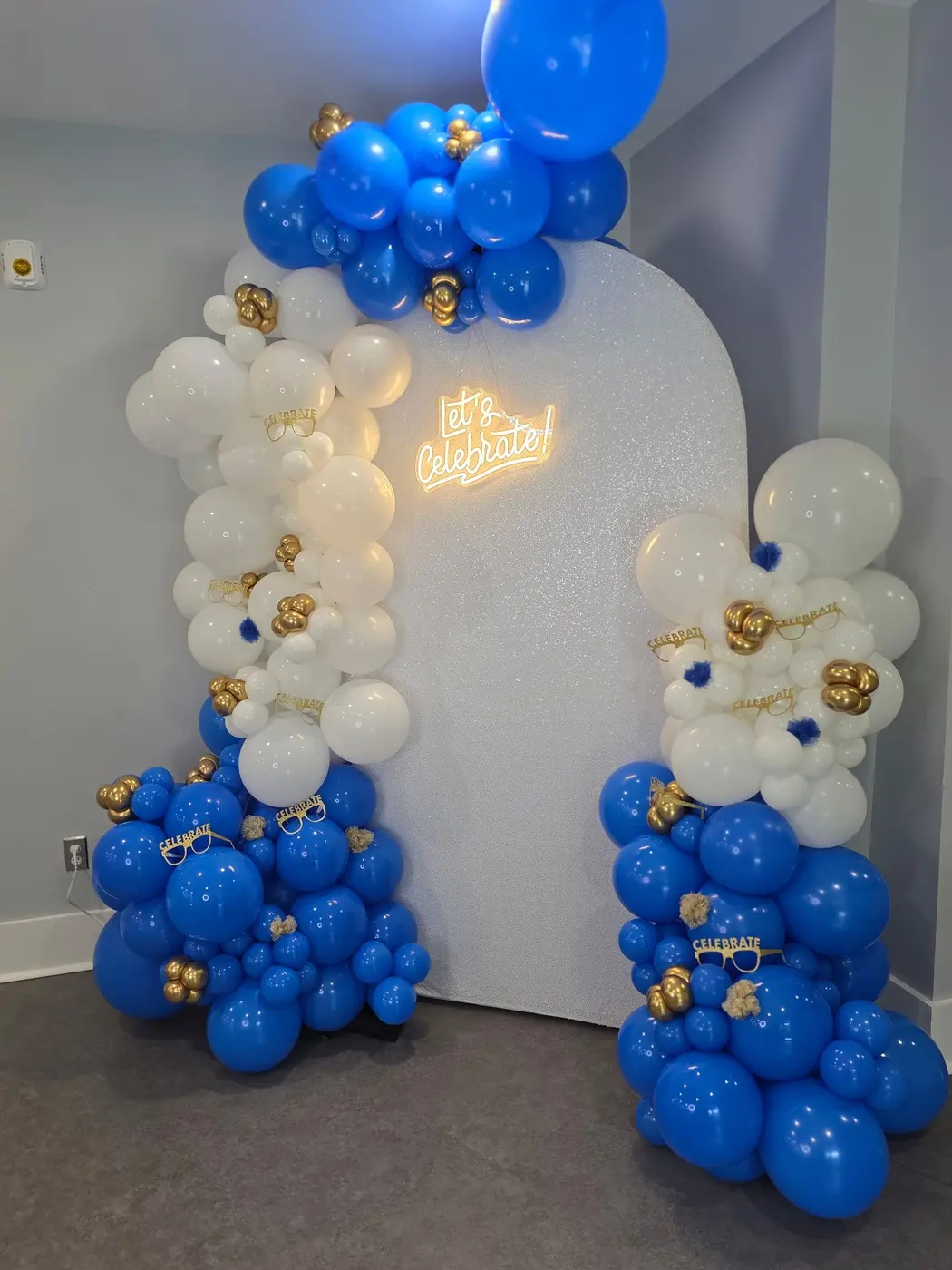 Royal blue, white and gold balloon garland on an arched backdrop, by Balloon Events by Gigi, Rochester NY