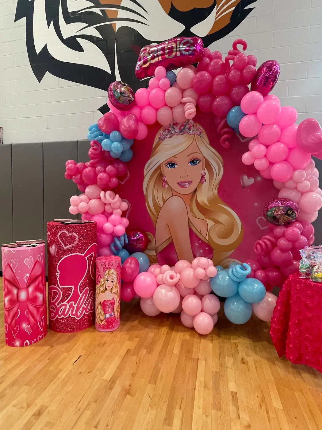 Hot pink and blush balloon arch around a pink doll-themed birthday backdrop, by Balloon Events by Gigi, Rochester NY