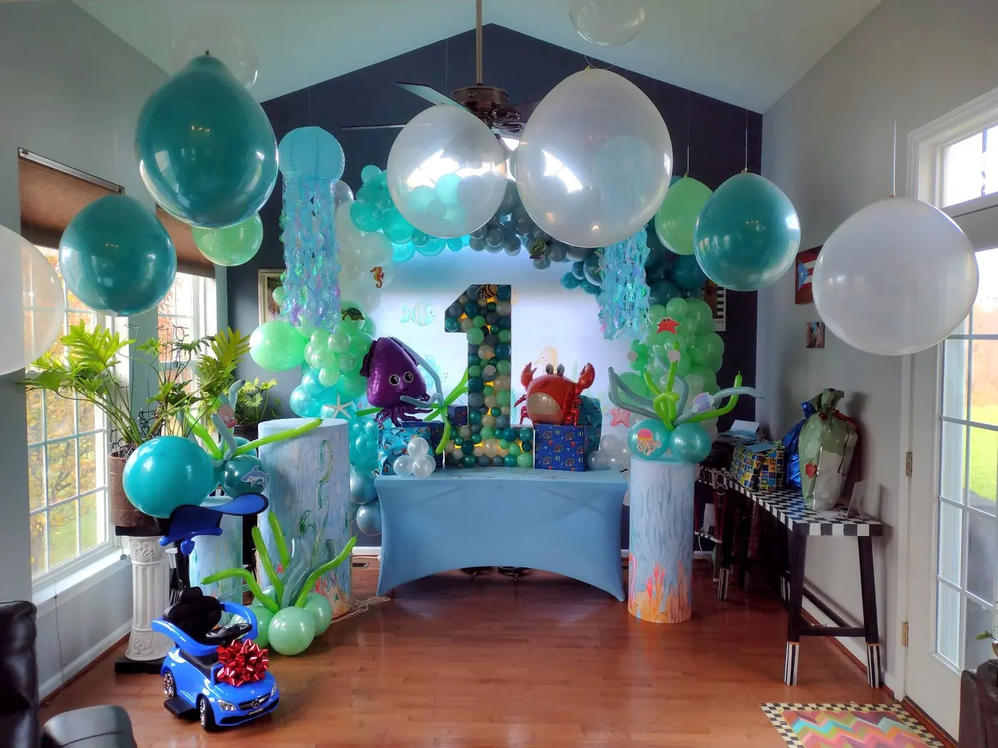 Teal, blue and white balloons over an under-the-sea first birthday table, by Balloon Events by Gigi, Rochester NY
